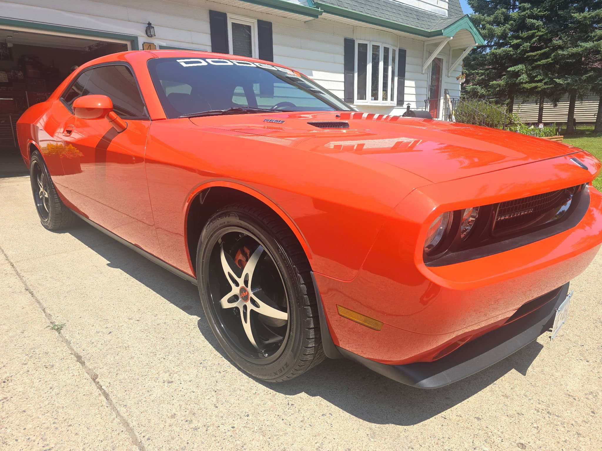 Orange Dodge Challenger with Cole's Detailing van